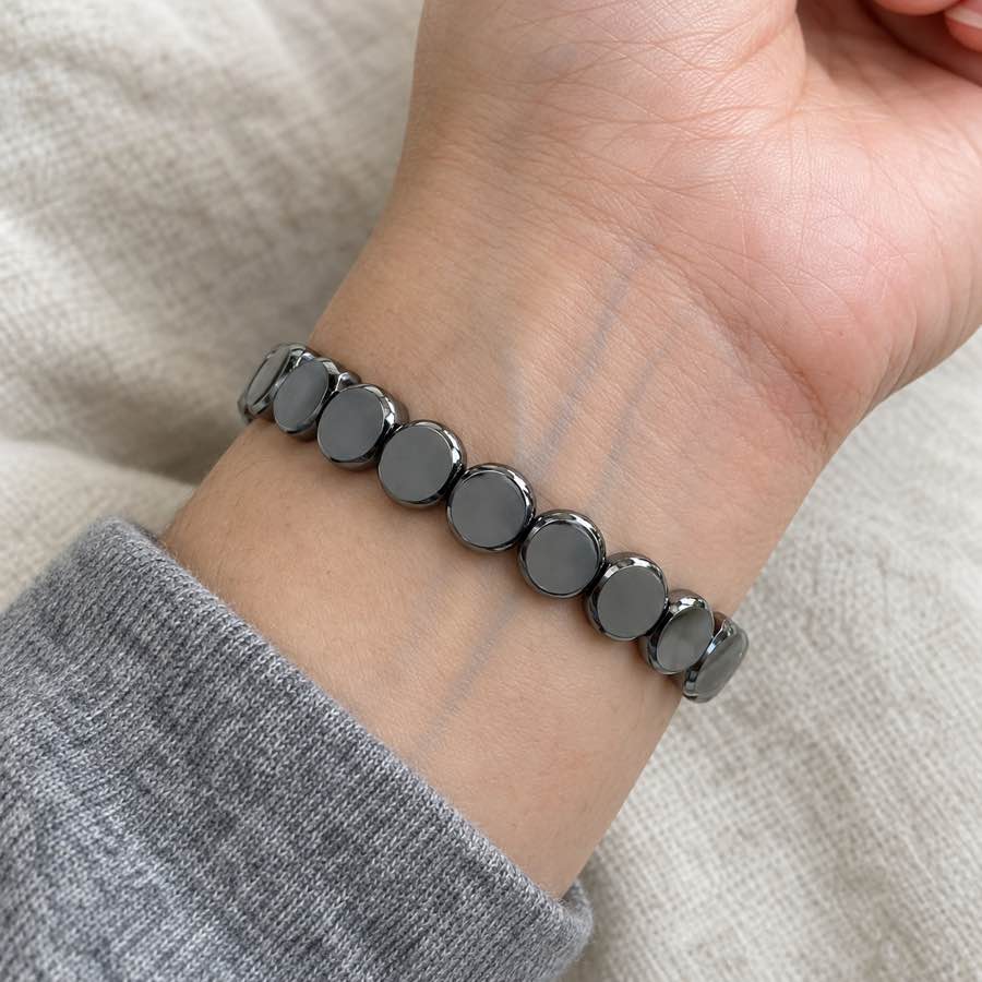 The dark HAIMA bracelet worn on the inner wrist